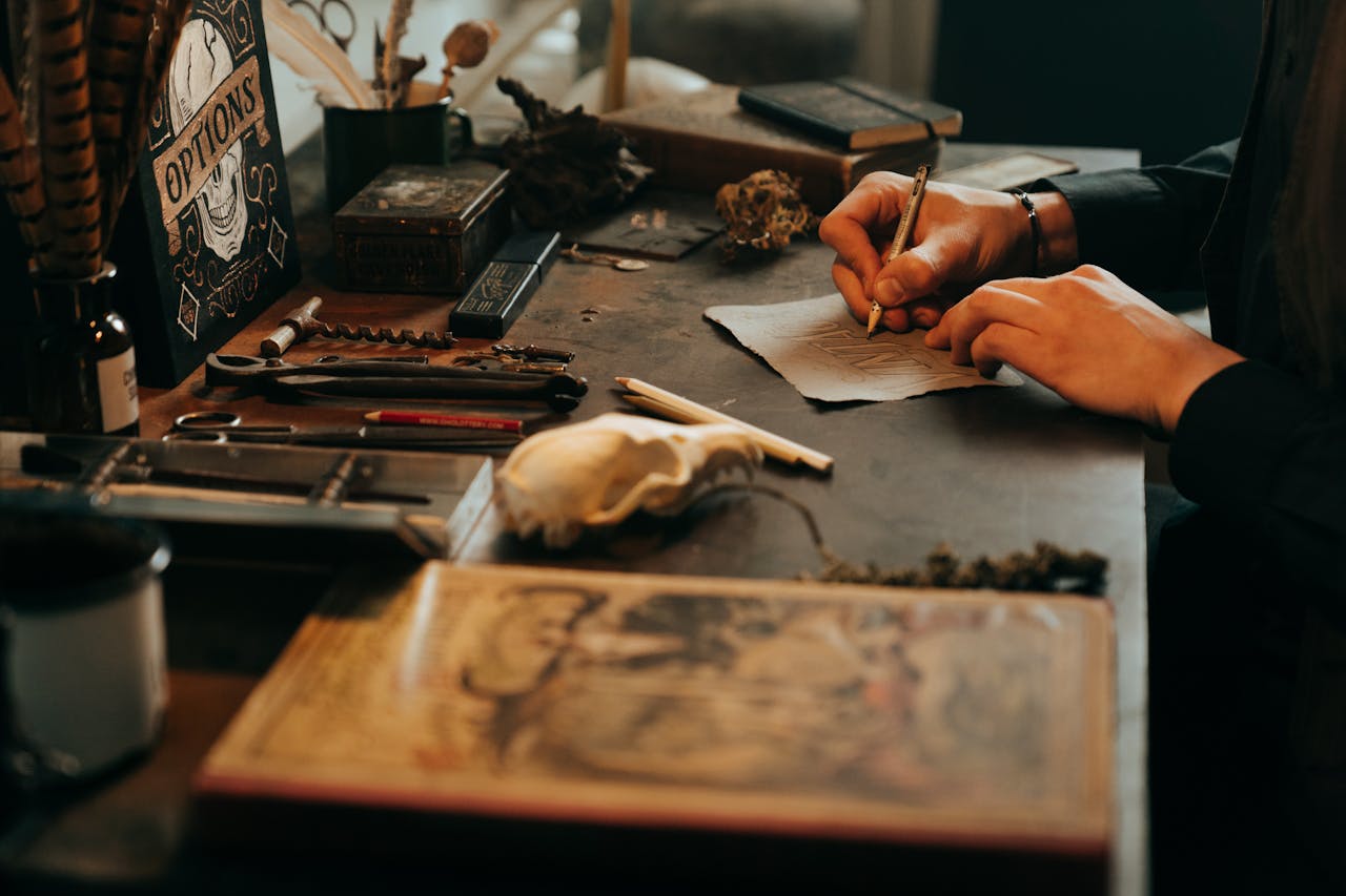 digital A vintage workspace with a skull, tools, and hands sketching, exuding a rustic, mysterious vibe.